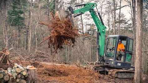 mini excavator digging out stumps|digging tree stumps.